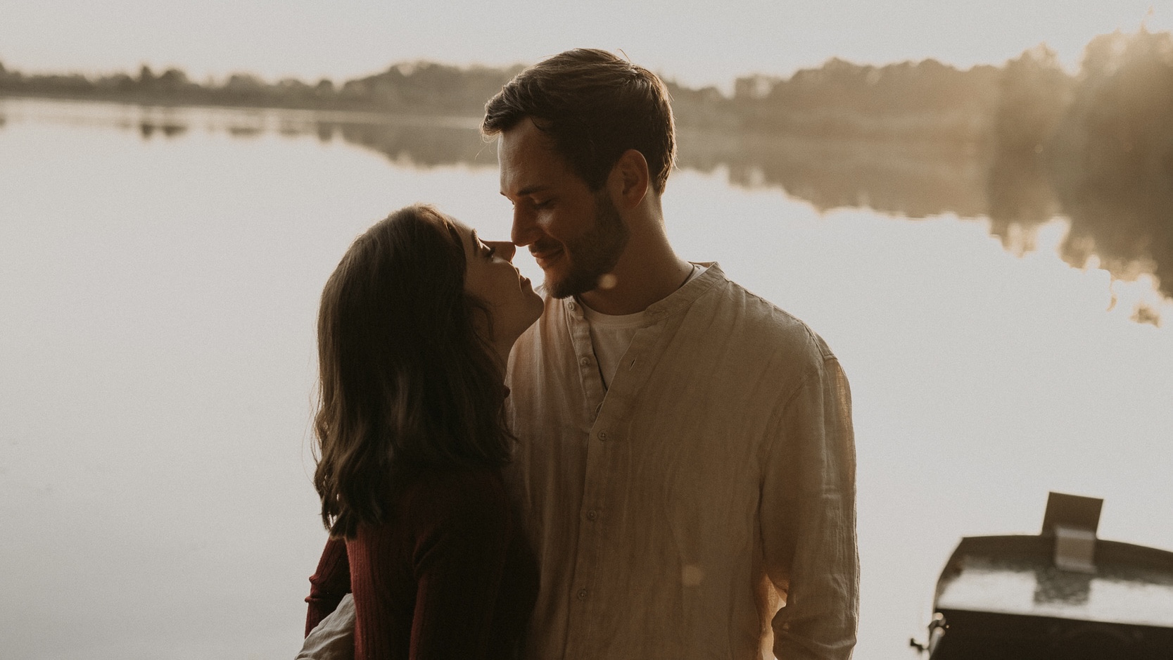 kissing in front of lake